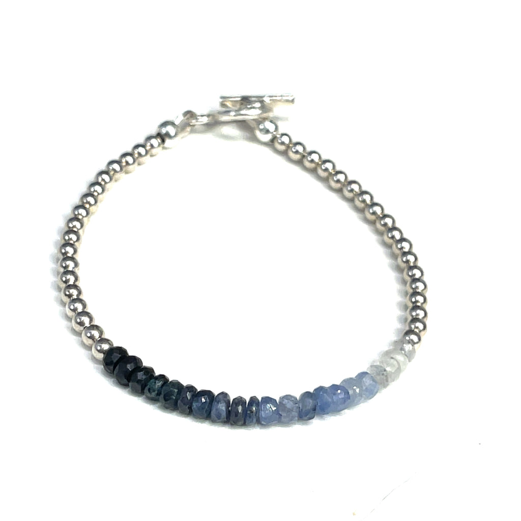 Genuine Sapphire gemstone bracelet with sterling silver beads and  toggle clasp by Hidden Jewel on a white background front and center overview. 