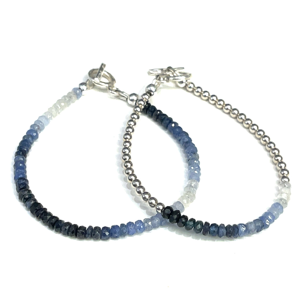 Genuine Sapphire gemstone bracelet with sterling silver toggle clasp by Hidden Jewel on a white background close up front overview. 