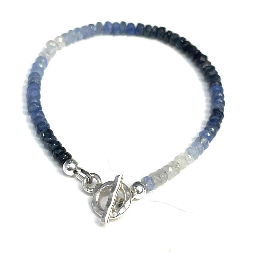 Genuine Sapphire gemstone bracelet with sterling silver toggle clasp by Hidden Jewel on a white background toggle back overview. 