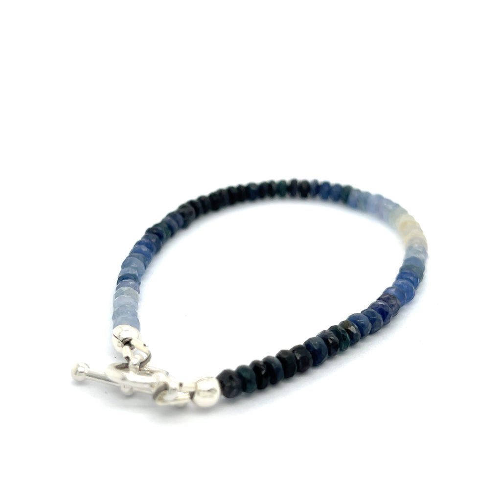 Genuine Sapphire gemstone bracelet with sterling silver toggle clasp by Hidden Jewel on a white background toggle right angle overview. 