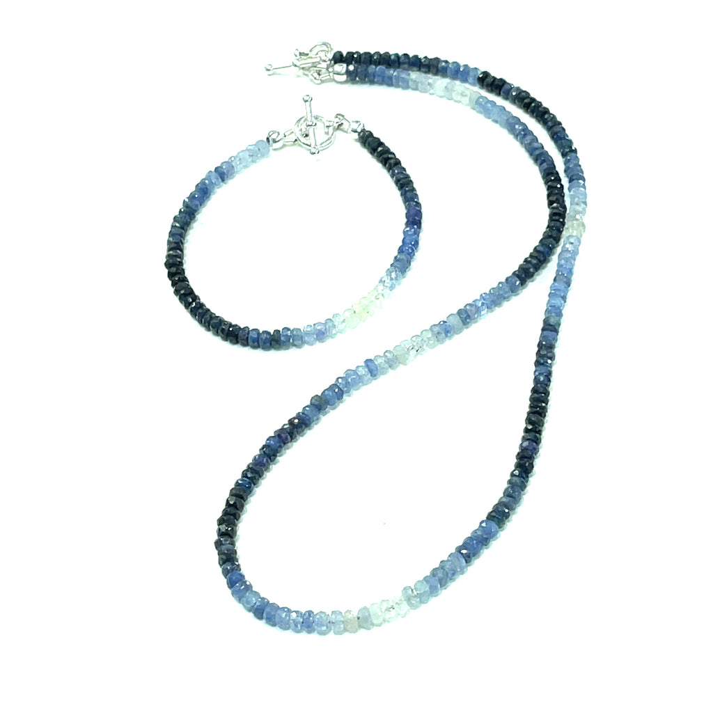 Genuine Sapphire gemstone bracelet with sterling silver toggle clasp with its matching necklace by Hidden Jewel on a white background front center overview. 