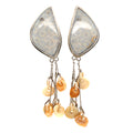 Genuine fossil coral earrings in sterling silver with flower-like patterns on a white background center front hanging overview. 