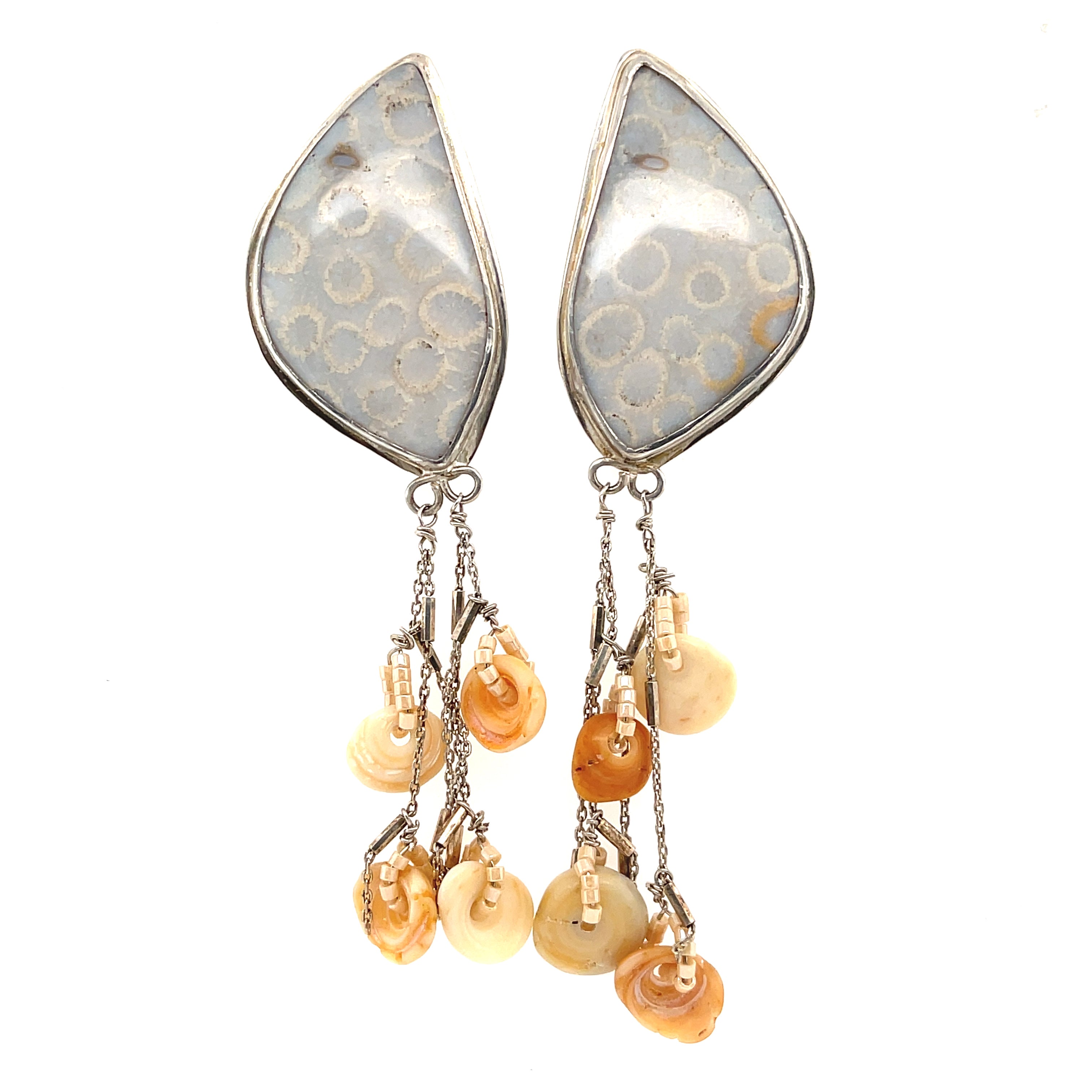 Genuine fossil coral earrings in sterling silver with flower-like patterns on a white background center front hanging overview. 
