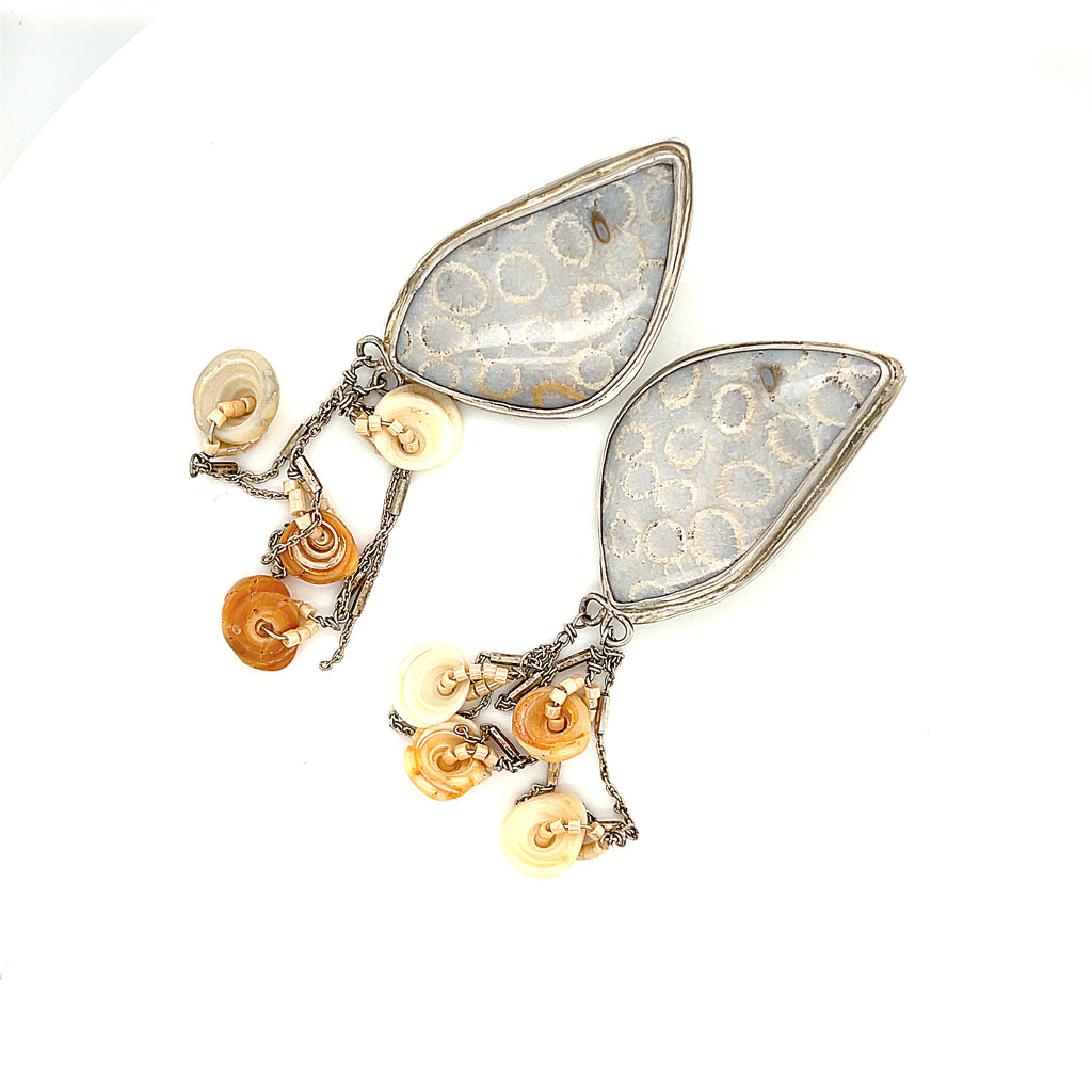 Genuine fossil coral earrings in sterling silver with flower-like patterns on a white background center front right angle overview. 