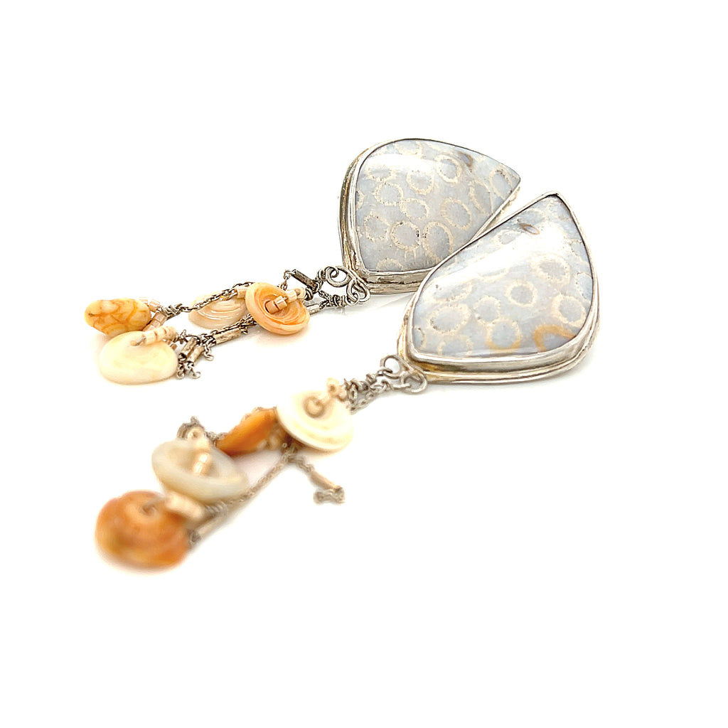 Genuine fossil coral earrings in sterling silver with flower-like patterns on a white background slight left diagonal front overview. 