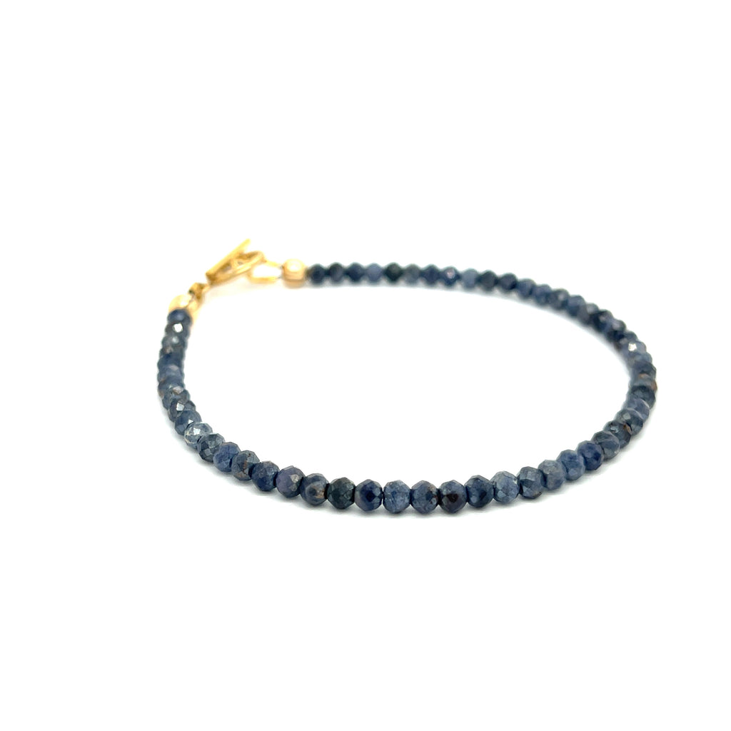  Gold-filled toggle clasp detail on handcrafted sapphire bracelet on a white background  slight right angle front overview.