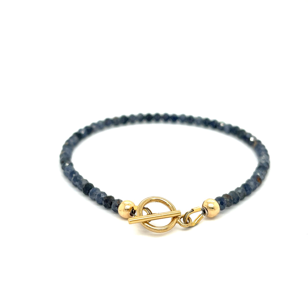  Gold-filled toggle clasp detail on handcrafted sapphire bracelet on a white background toggle forward overview.