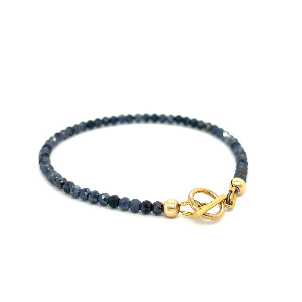  Gold-filled toggle clasp detail on handcrafted sapphire bracelet on a white background toggle right angled overview.