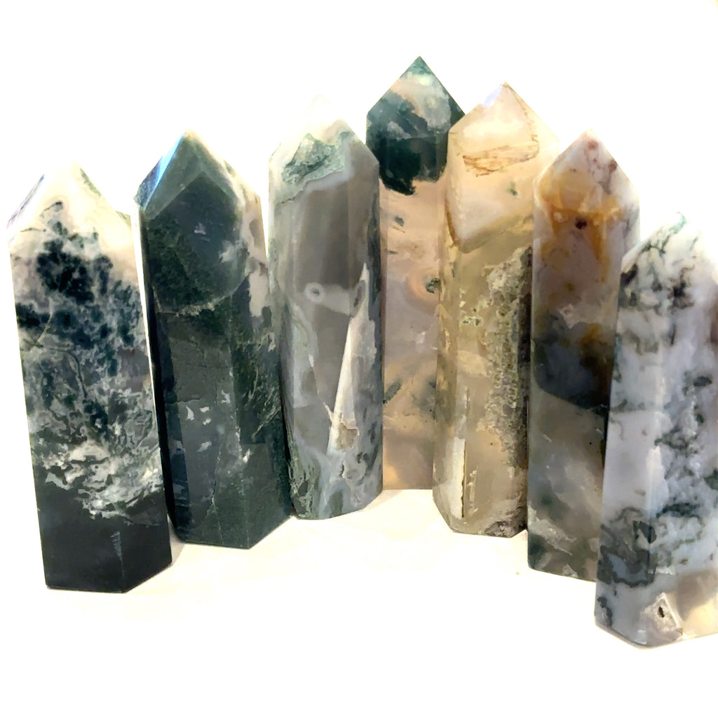 Group of Moss Agate towers showing natural variations in color and pattern. On a white background, front overview.