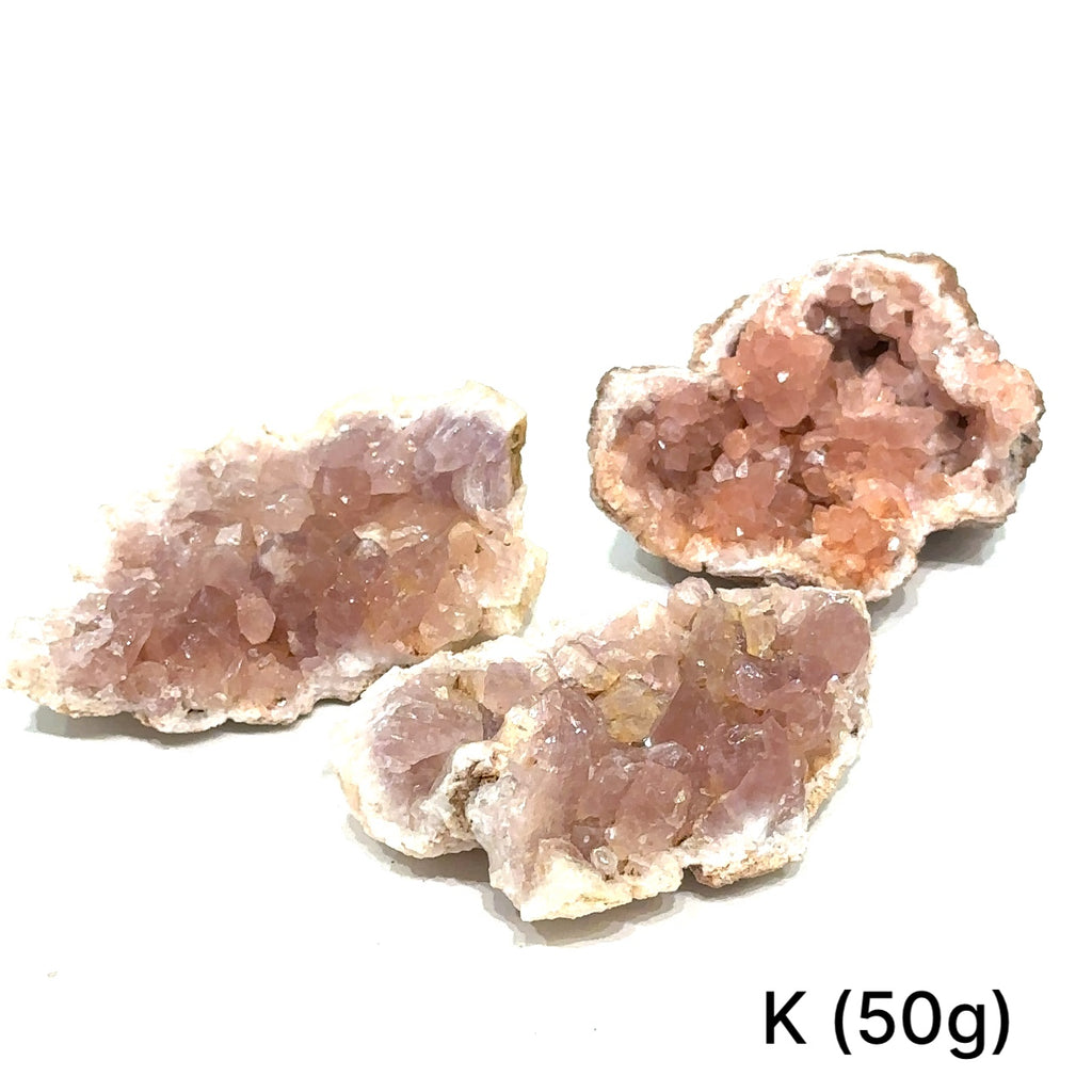 Group of pink amethyst clusters on white background showing natural variations on white # K front view