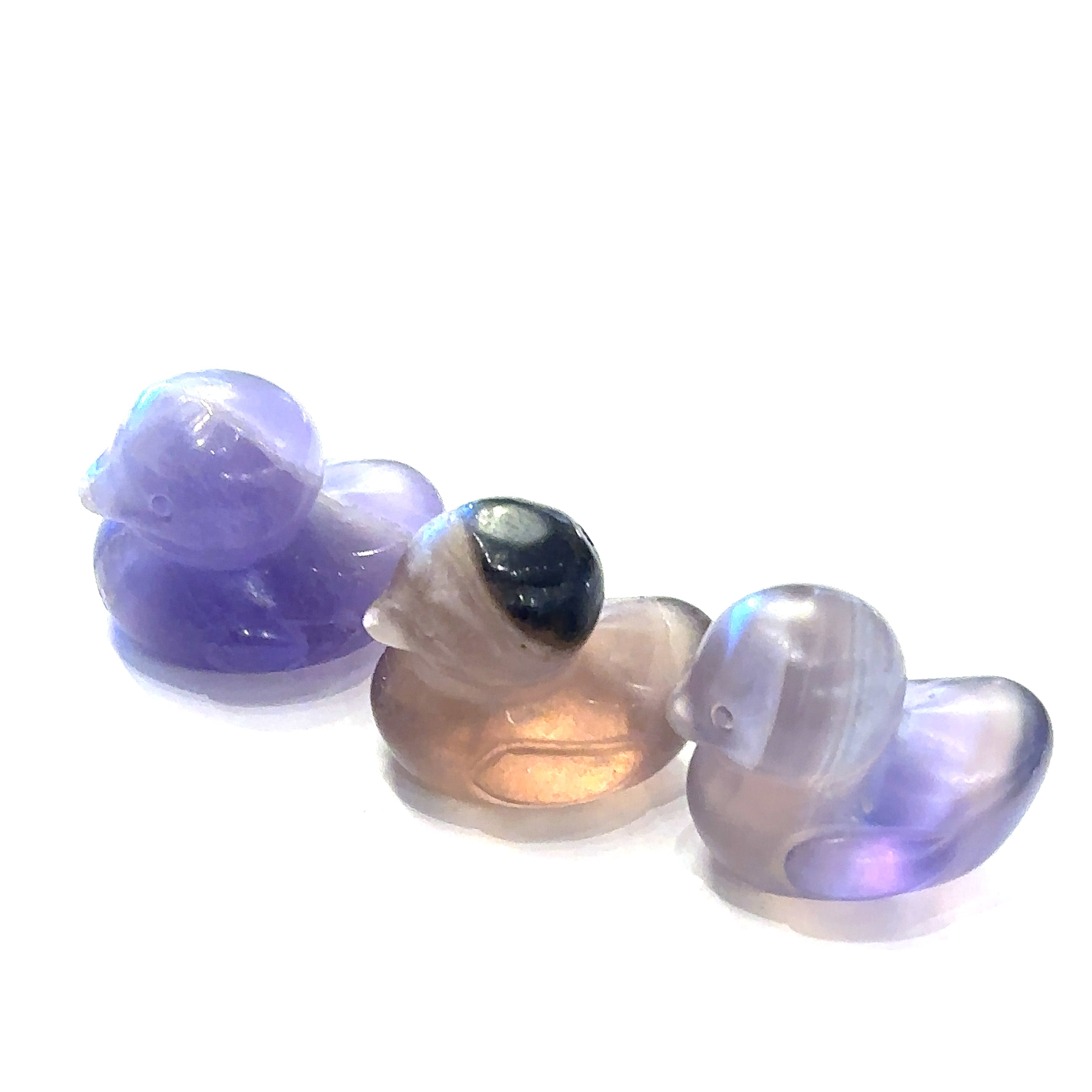 Hand-carved gemstone sculpture of a duck made from Rainbow Fluorite, with a smooth finish on a white background front view