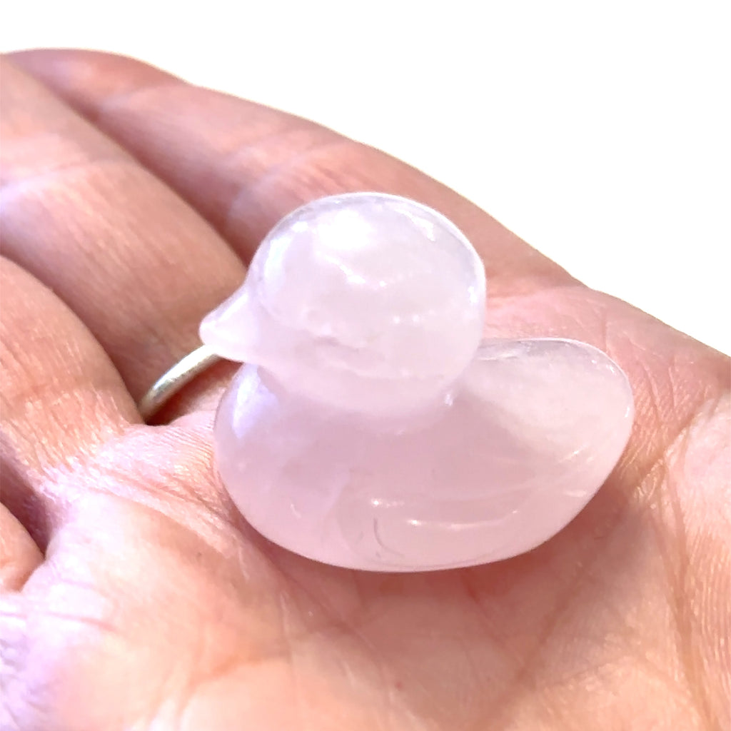 Hand-carved gemstone sculpture of a duck made from Rose Quartz, with a smooth finish on a white background front view