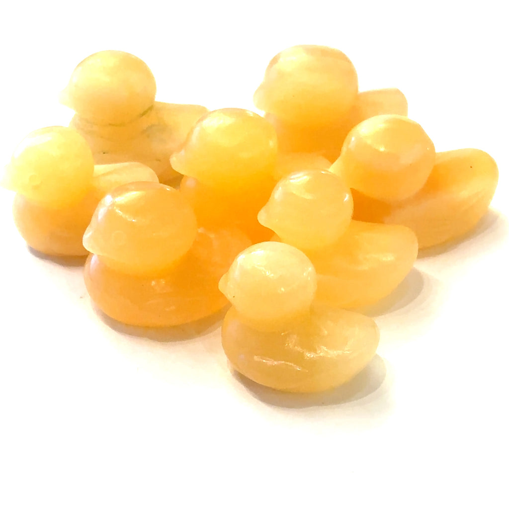 Hand-carved gemstone sculpture of a duck made from orange calcite, with a smooth finish on a white background front view