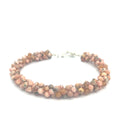 Hand-crocheted Rhodochrosite gemstone bracelet with sterling silver  toggle clasp on a white background front center overview.