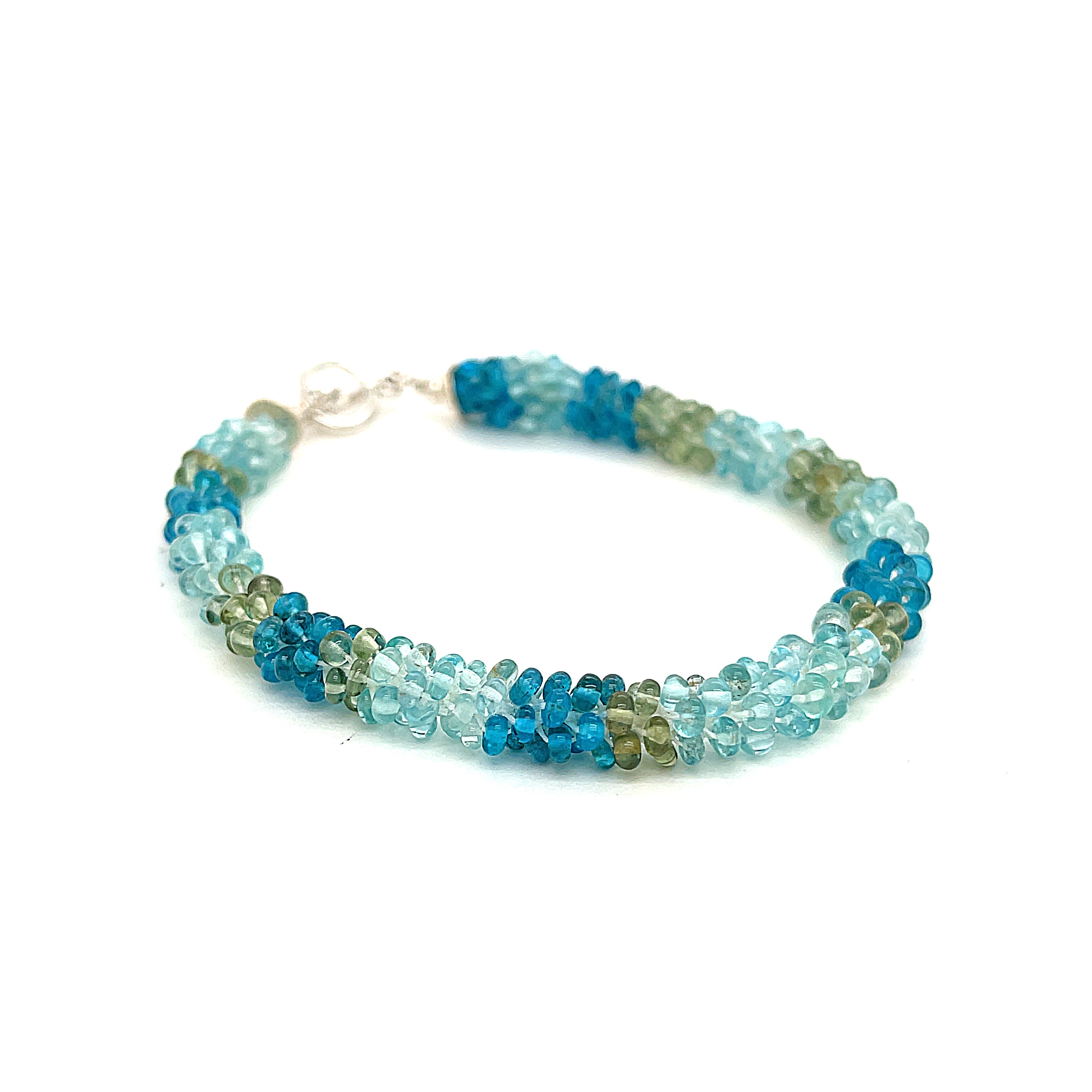Handcrafted Fluorite gemstone bracelet with sterling silver toggle on a white background, front slight right angle overview. 