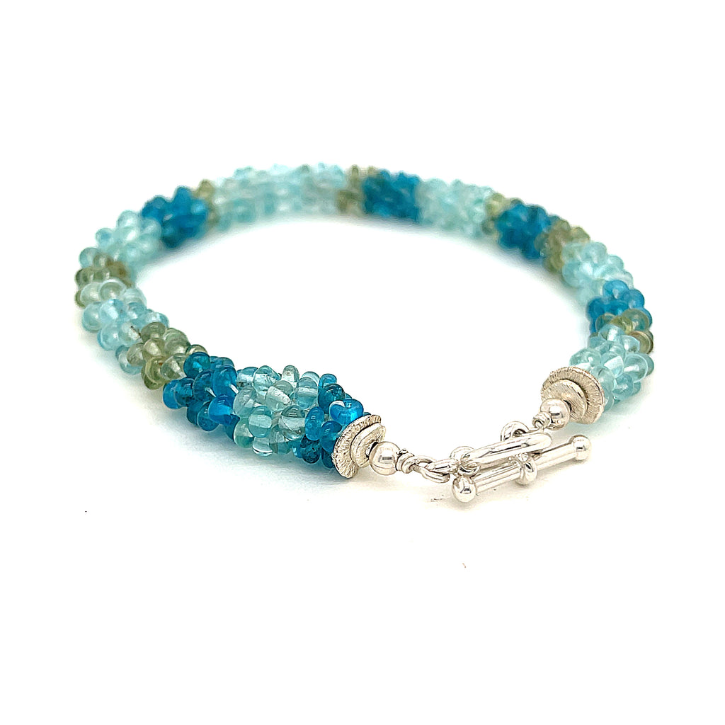Handcrafted Fluorite gemstone bracelet with sterling silver toggle on a white background, toggle back slight right angle overview. 