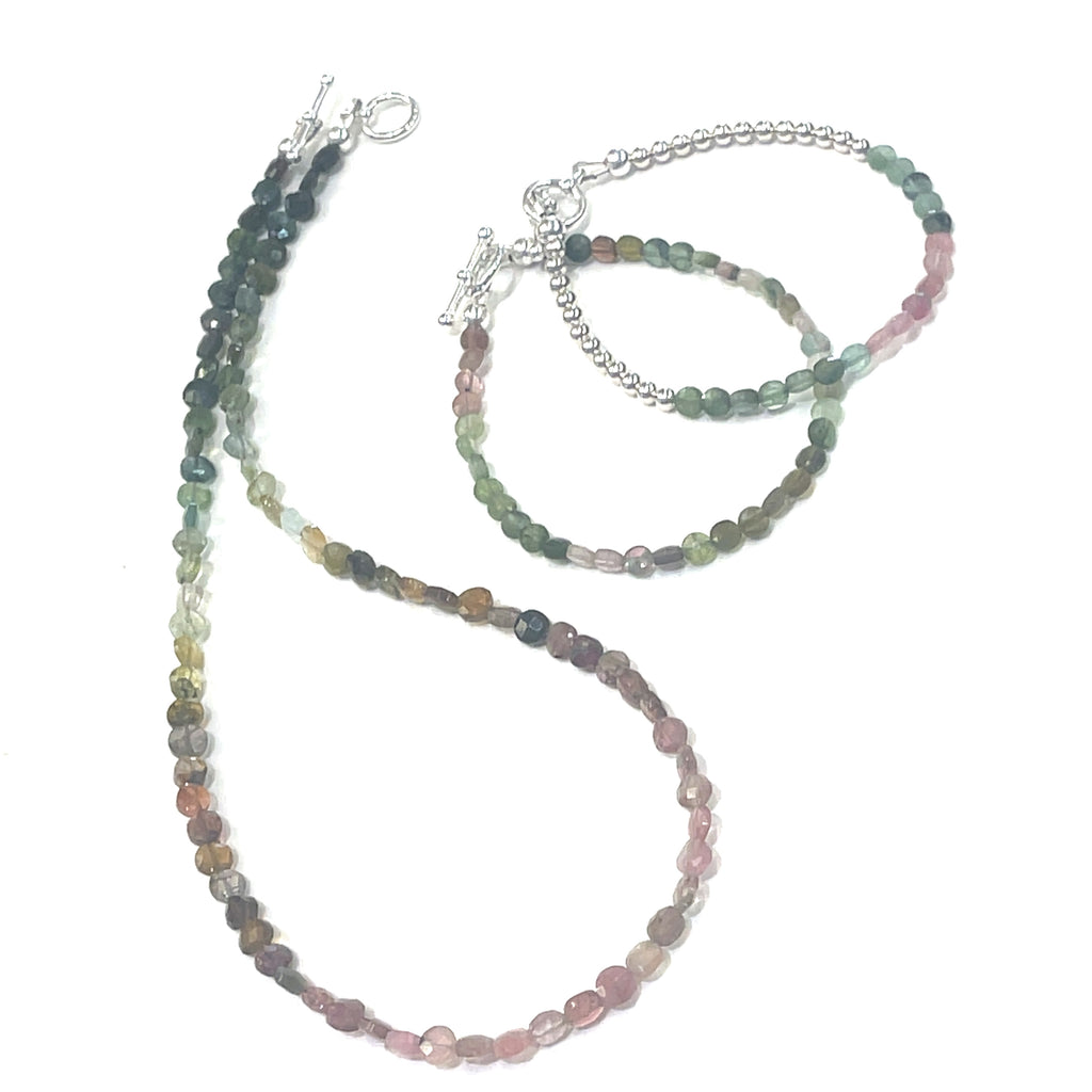 Handcrafted Watermelon Tourmaline gemstone necklace with sterling silver accents by Hidden Jewel on a white background center long overview with matching bracelets.