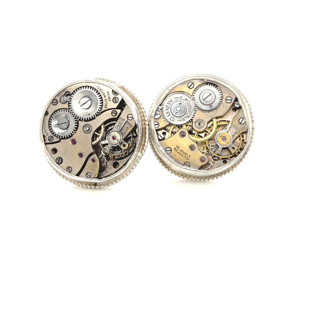Handcrafted antique watch movement cuff links in sterling silver on a white background close up front  overview.
