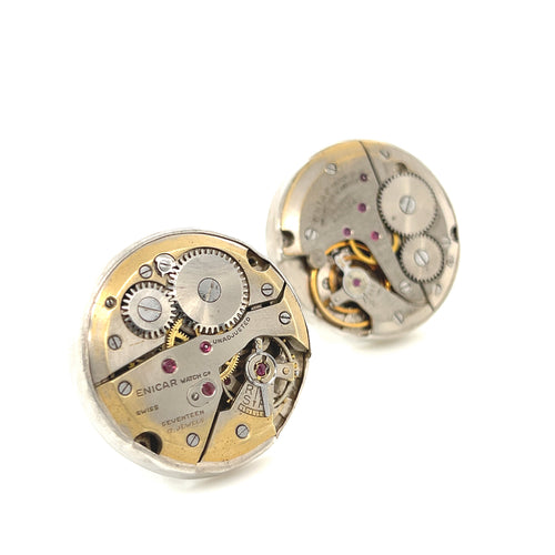 Handcrafted antique watch movement cuff links in sterling silver on a white background close up front view.