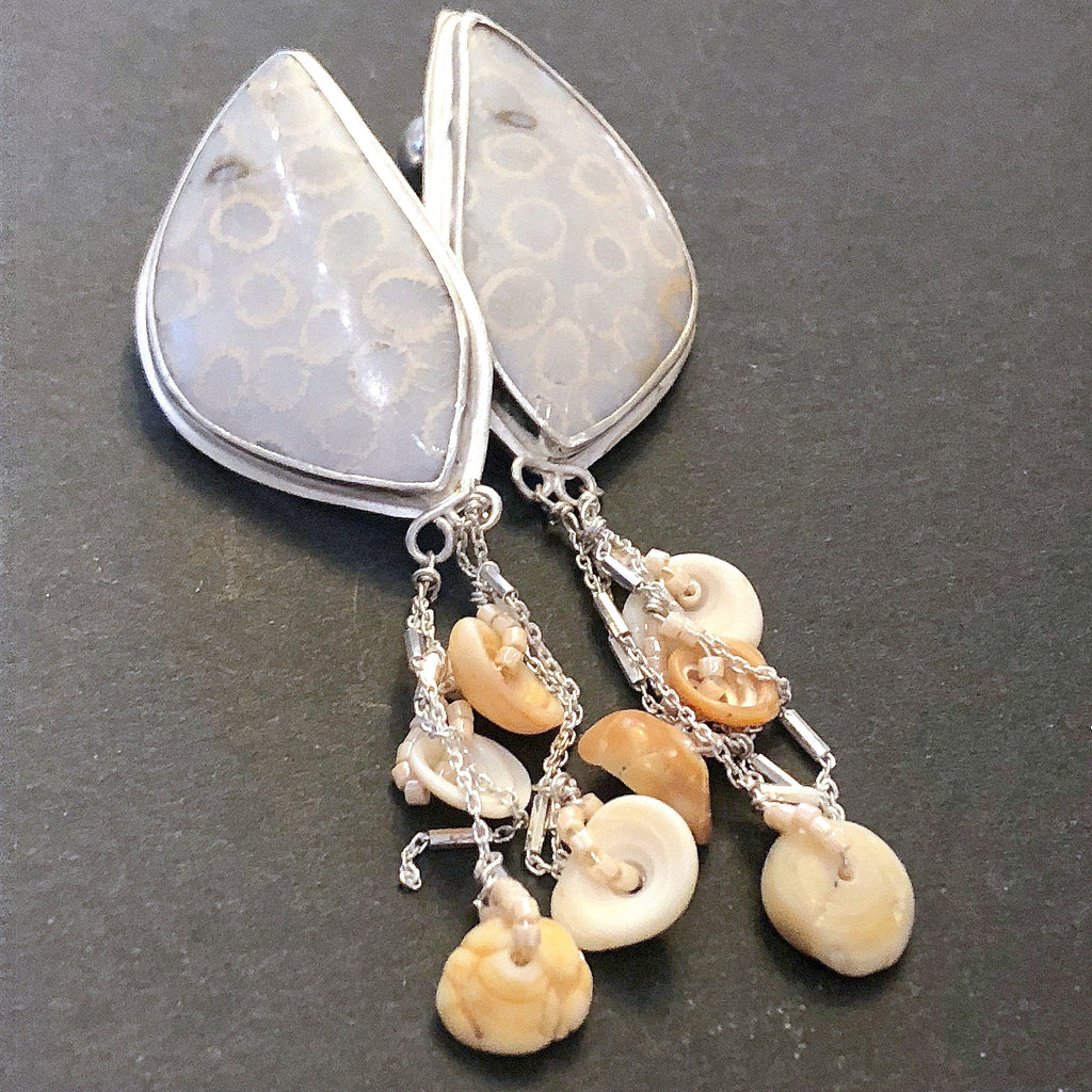 Handcrafted fossil coral gemstone studs by Hidden Jewel Boston on a black background center front overview. 