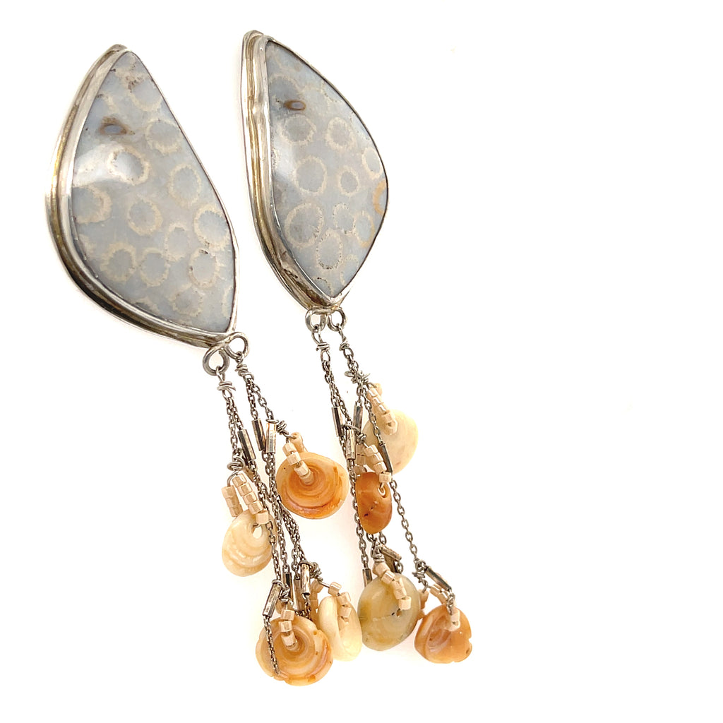 Handcrafted fossil coral gemstone studs by Hidden Jewel Boston on a white background center front hanging left angle overview. 