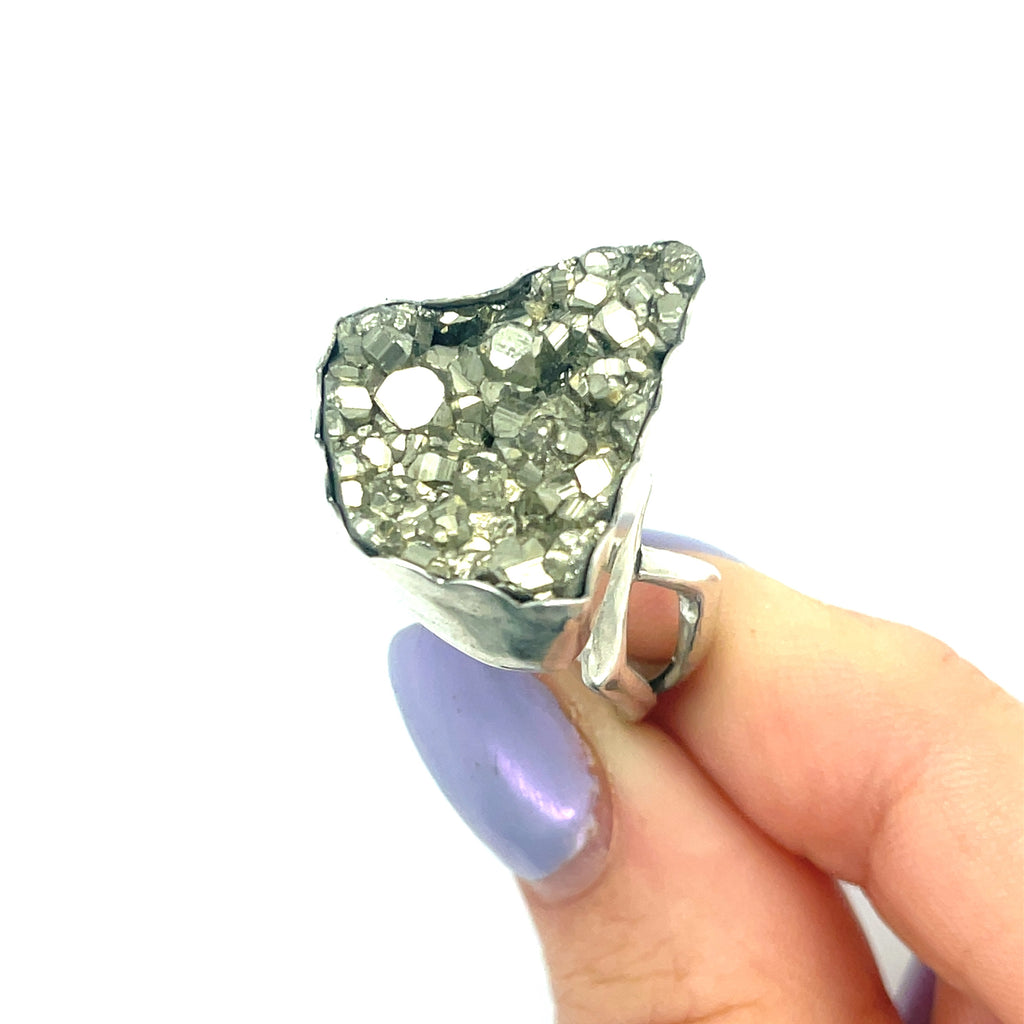 Handcrafted sterling silver Pyrite gemstone ring — Hidden Jewel Boston in models finger tips on a white background front  close up overview. 