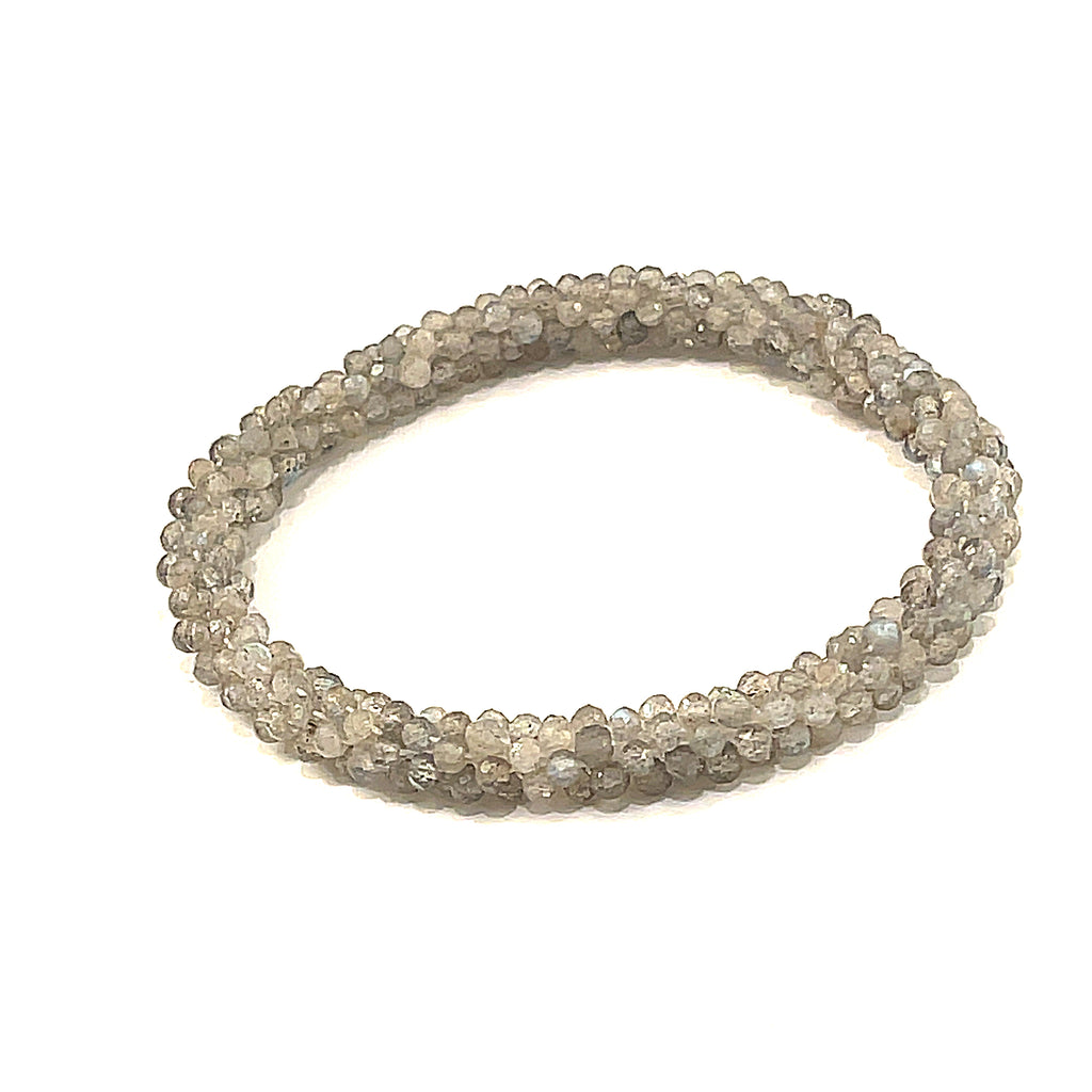 Labradorite roll-on bracelet with shimmering blue flashes front close up overview. 