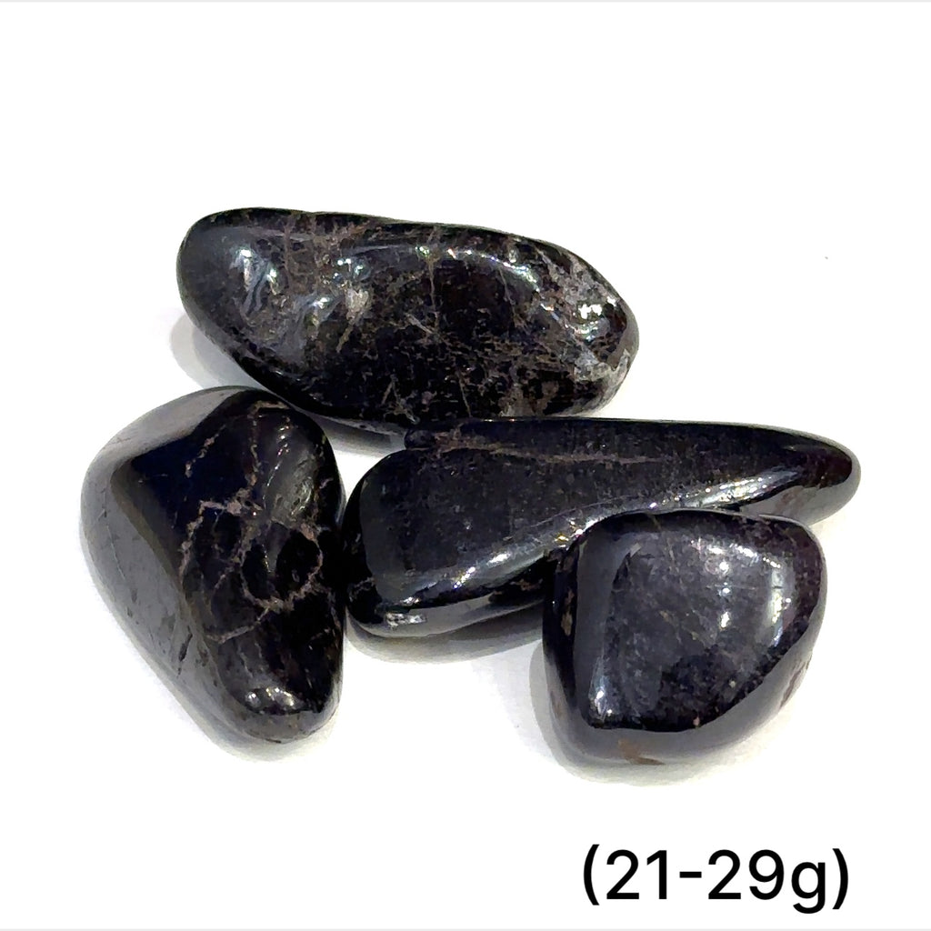 Multiple Purpurite tumbled stones arranged on white background showing variations sizes (21-29g) on white background overview