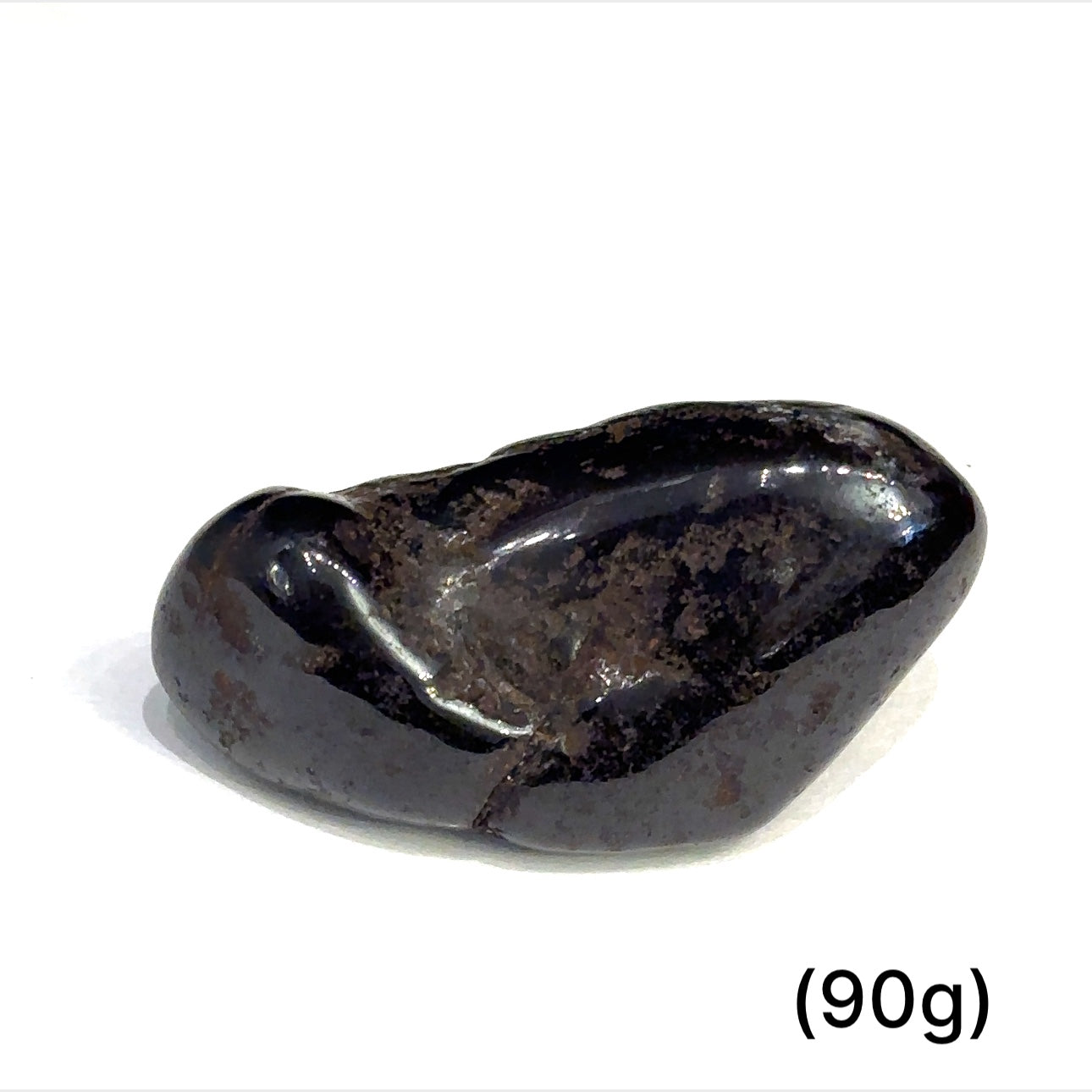Multiple Purpurite tumbled stones arranged on white background showing variations sizes (90g) on white background overview
