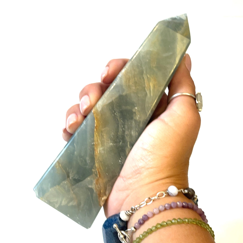 One #2  3XL large sizes of  blue onyx gemstone towers displayed in a group on a white background, front overview in a models hand to show the size. 