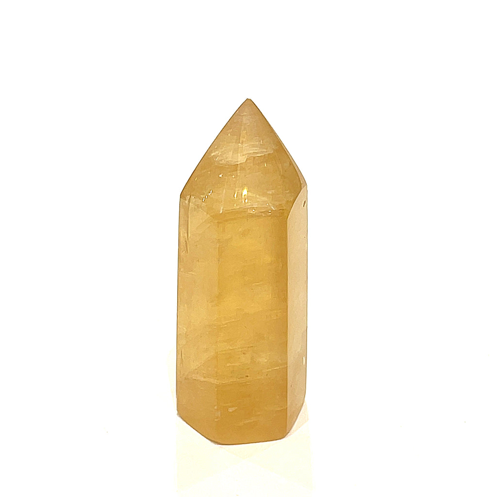 One Honey Calcite gemstone tower displayed on a white background, front view.