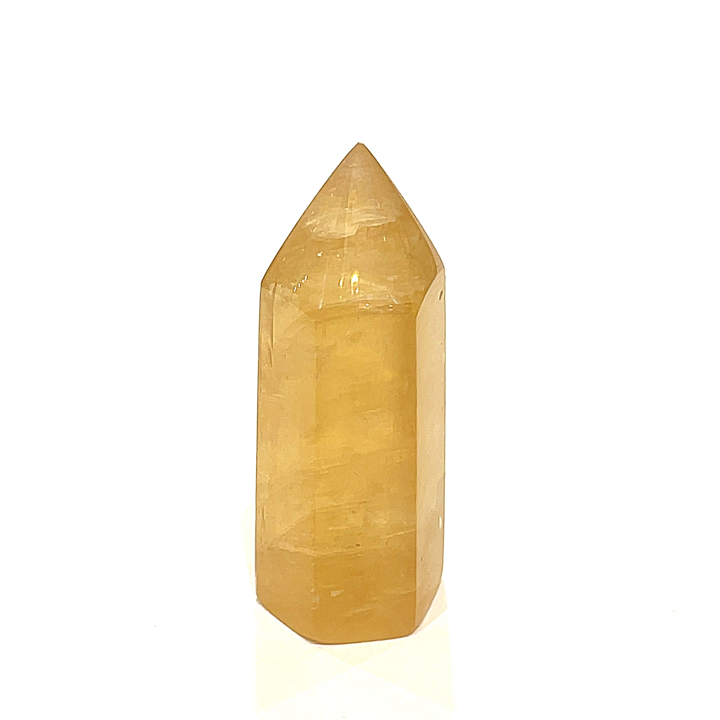 One Honey Calcite gemstone tower displayed on a white background, front view.