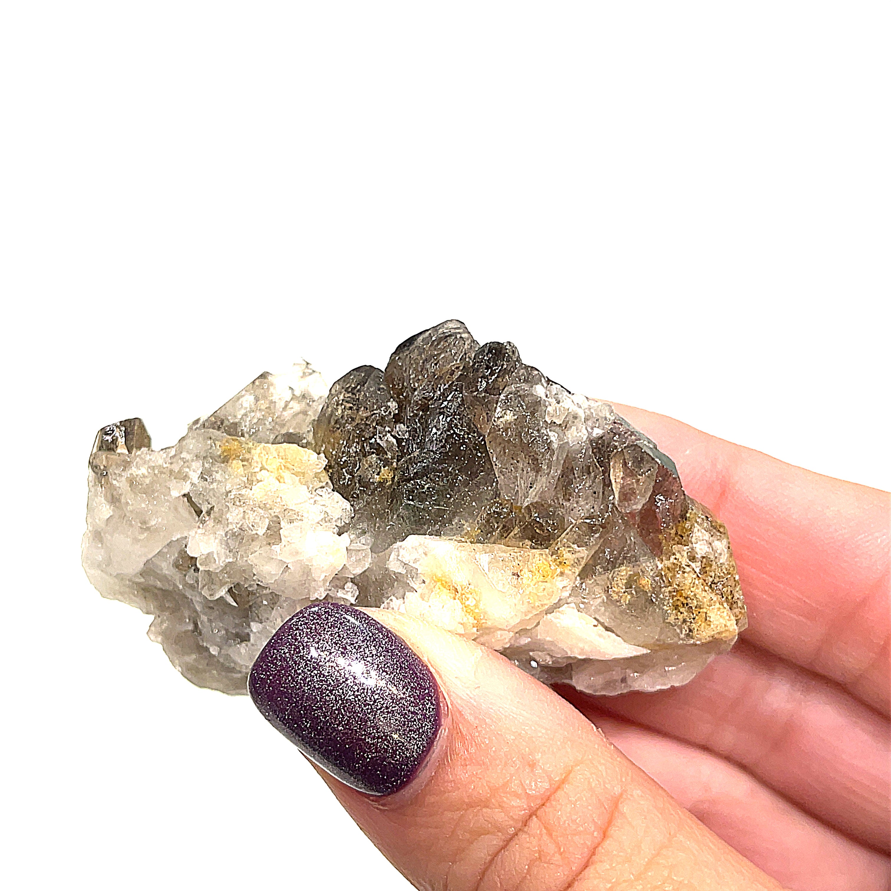 One medium Smokey Quartz cluster gemstone point with druzy sparkle in a models hand on a white background front view. 