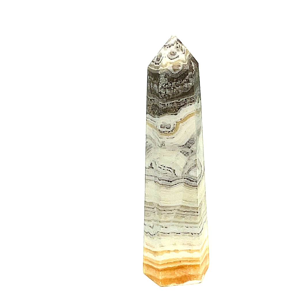 One yellow calcite gemstone towers with black dendritic patterns against a white background, front view. #1