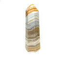 One yellow calcite gemstone towers with black dendritic patterns against a white background, front view. #2