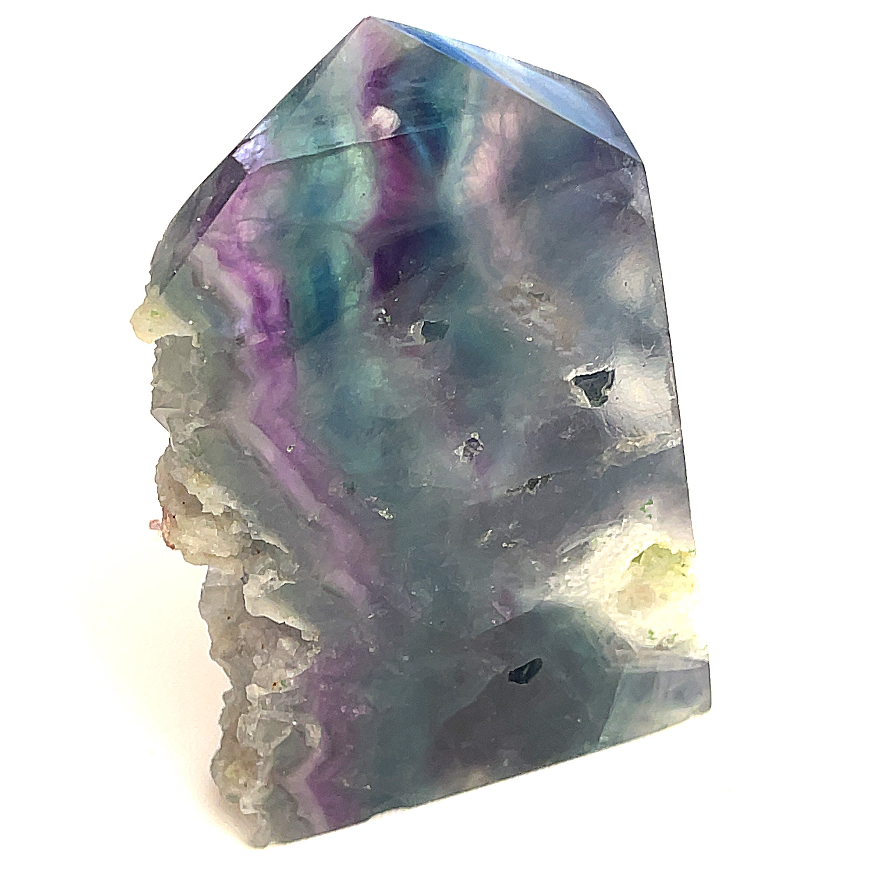 Rainbow Fluorite slab tower with a deep blue and deep purple banding under light on a white background, front view. 