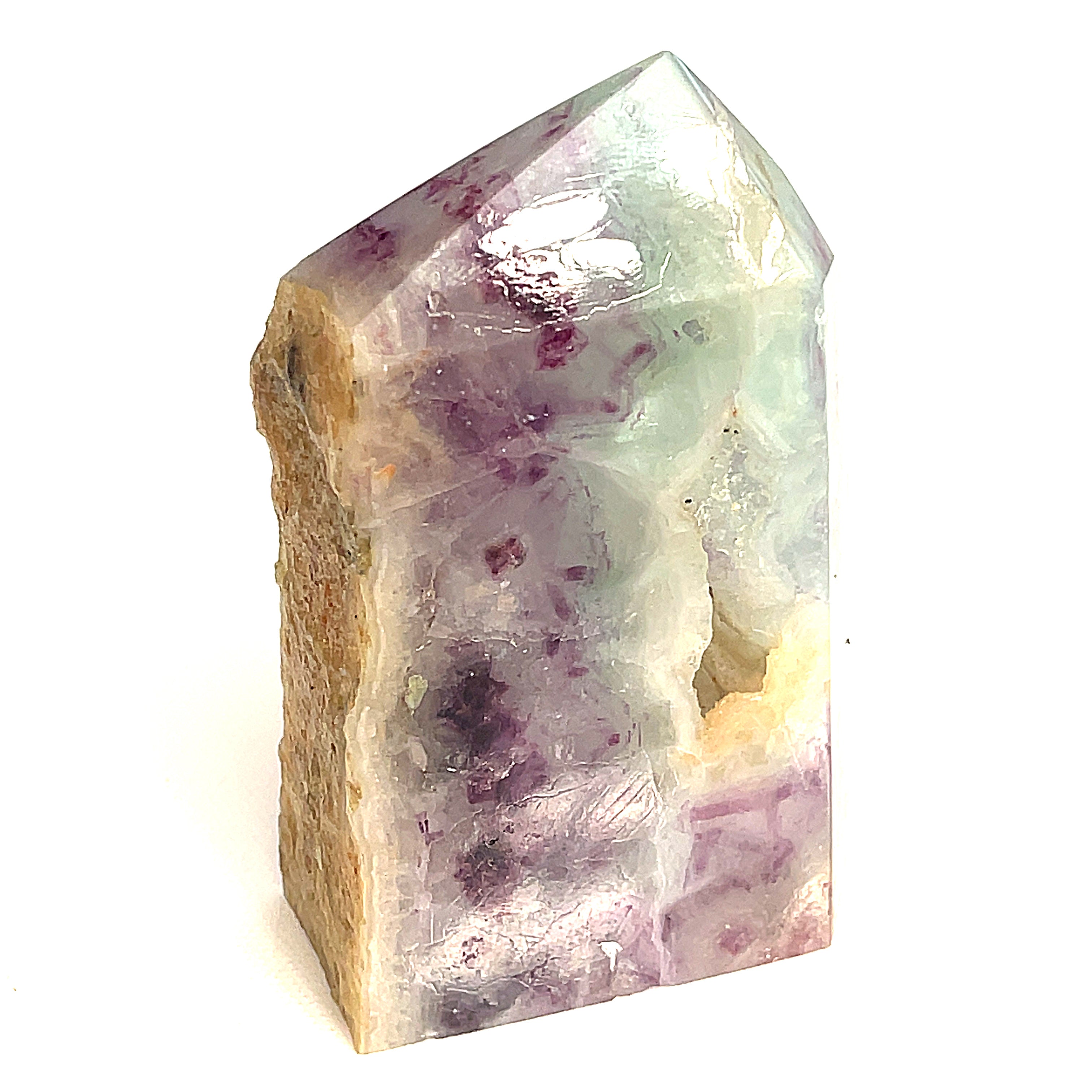 Rainbow Fluorite slab tower with blusish green and purple banding under light on a white background, front view. 