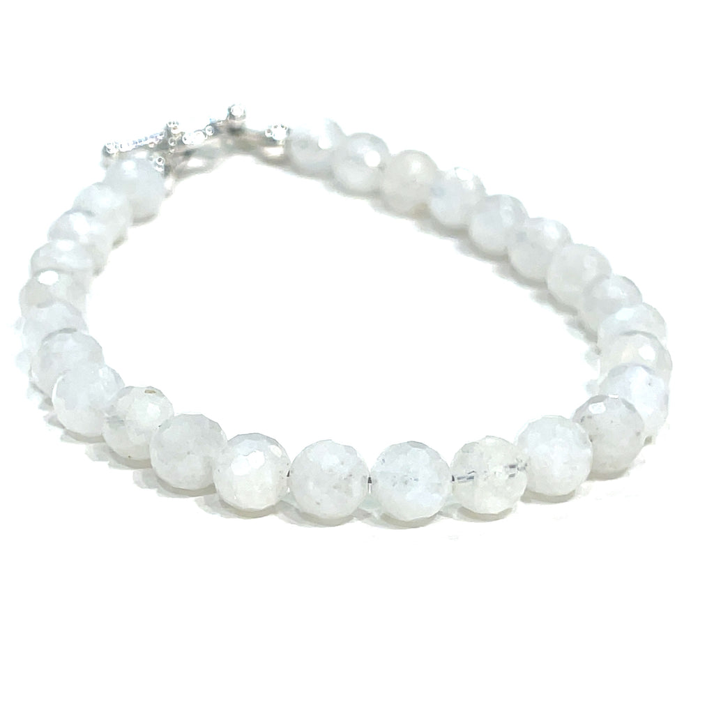 Rainbow Moonstone beaded bracelet with a sterling silver toggle on a white background front overview. 