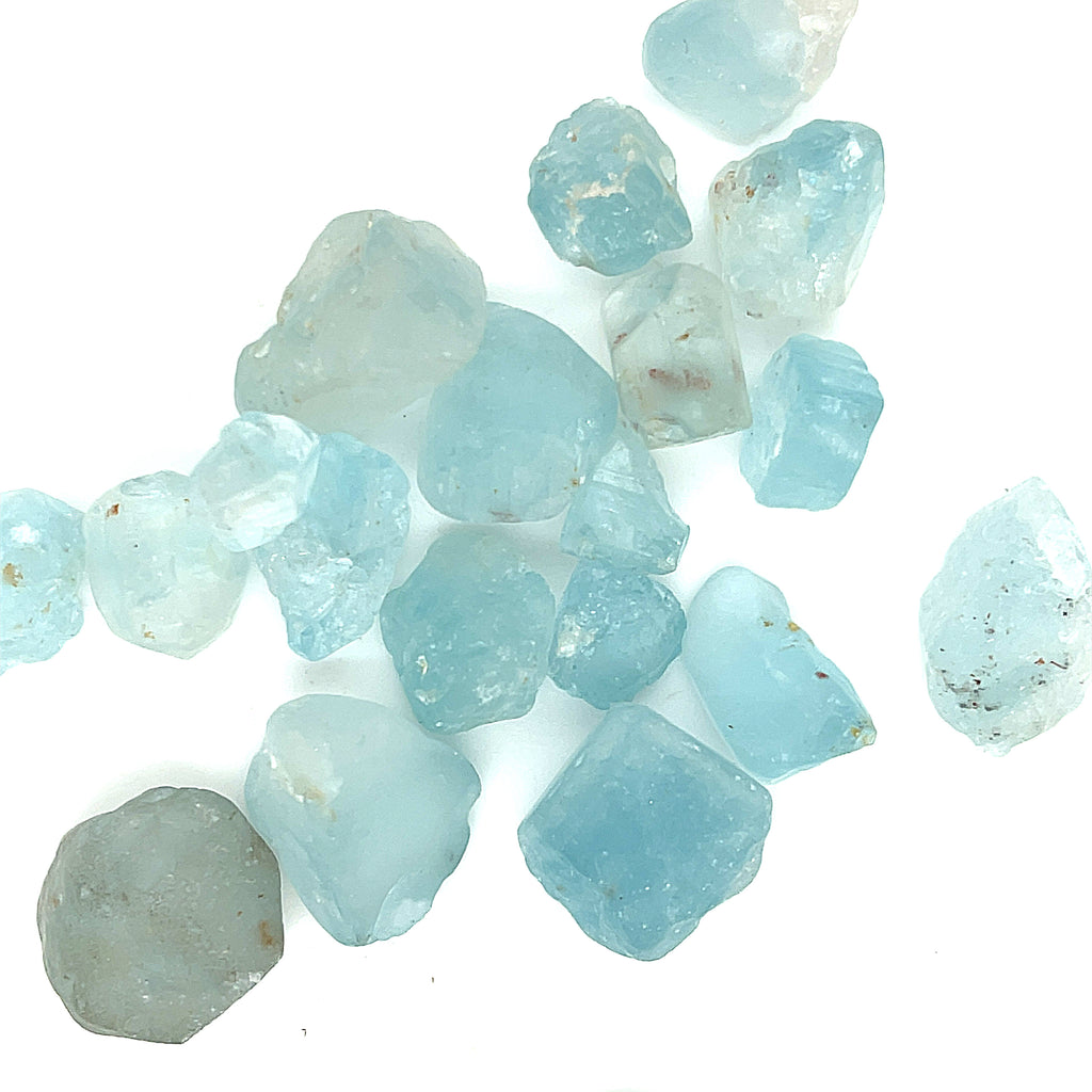 Raw Blue Topaz Gemstone on white grouping center  closeup overview 
