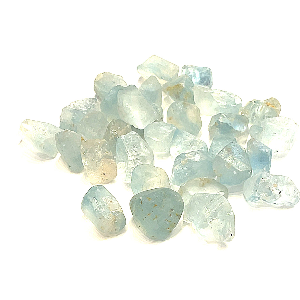 Raw Blue Topaz Gemstone on white grouping center  overview 