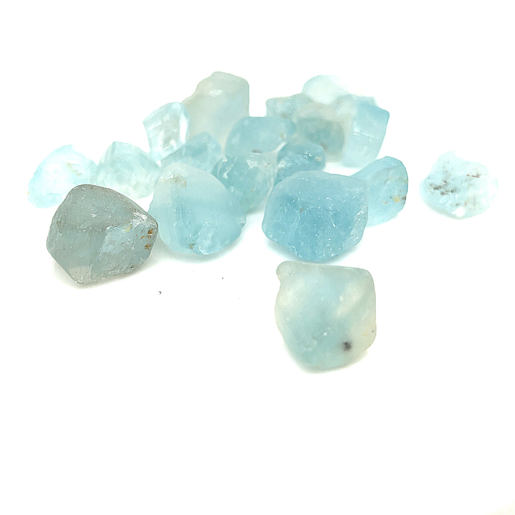 Raw Blue Topaz Gemstone on white grouping center up close front view 