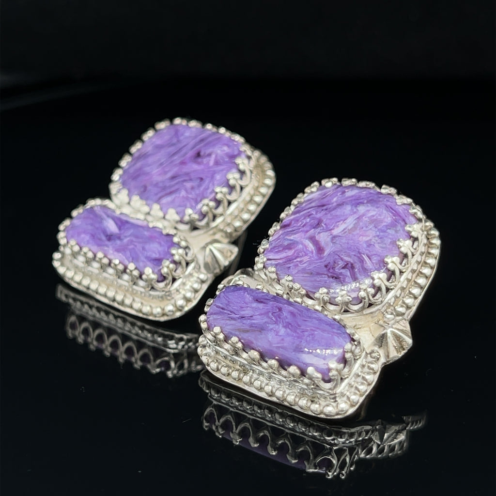 Rectangle Charoite double stone sterling silver earrings with swirling purple patterns studs an up-close front slight left view on a black background.