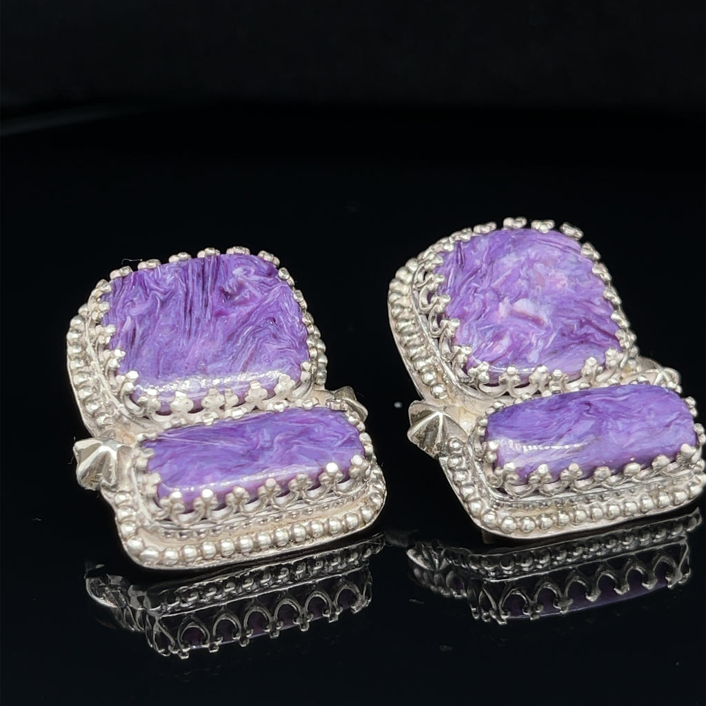 Rectangle Charoite double stone sterling silver earrings with swirling purple patterns studs an up-close front slight right view on a black background.