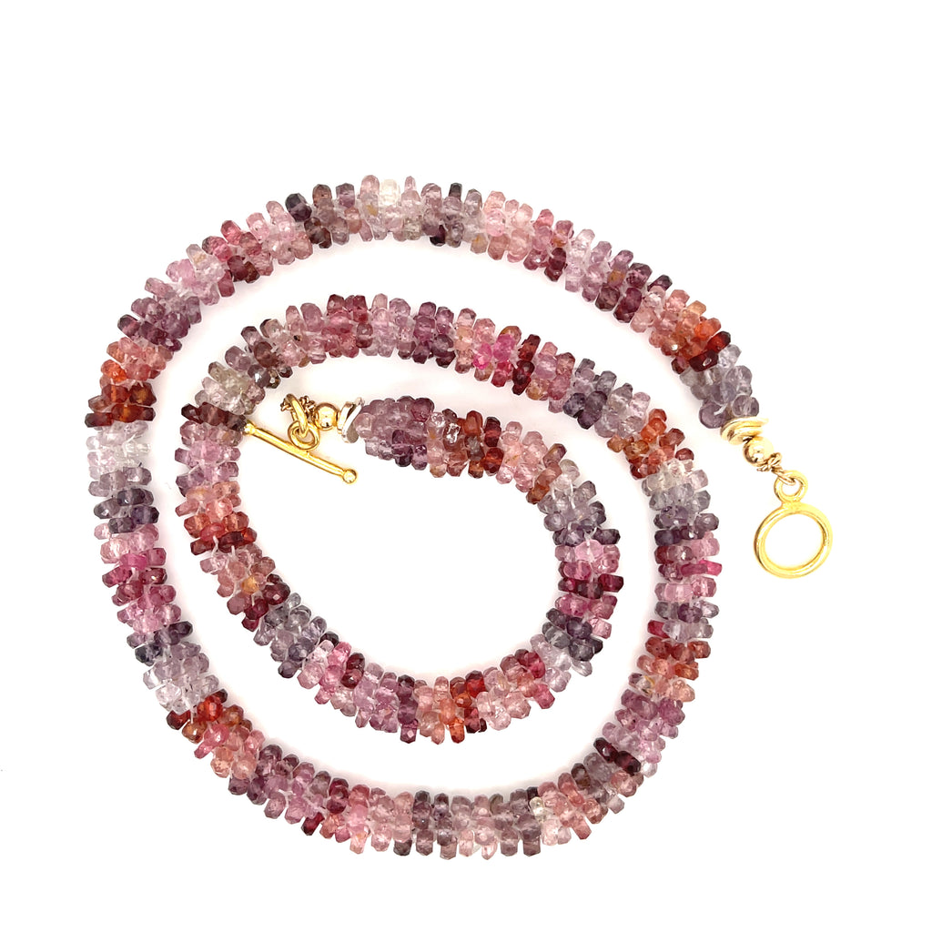 Red Spinel gemstone close-up — heart chakra and creativity healing stone on a white background spiral center overview.