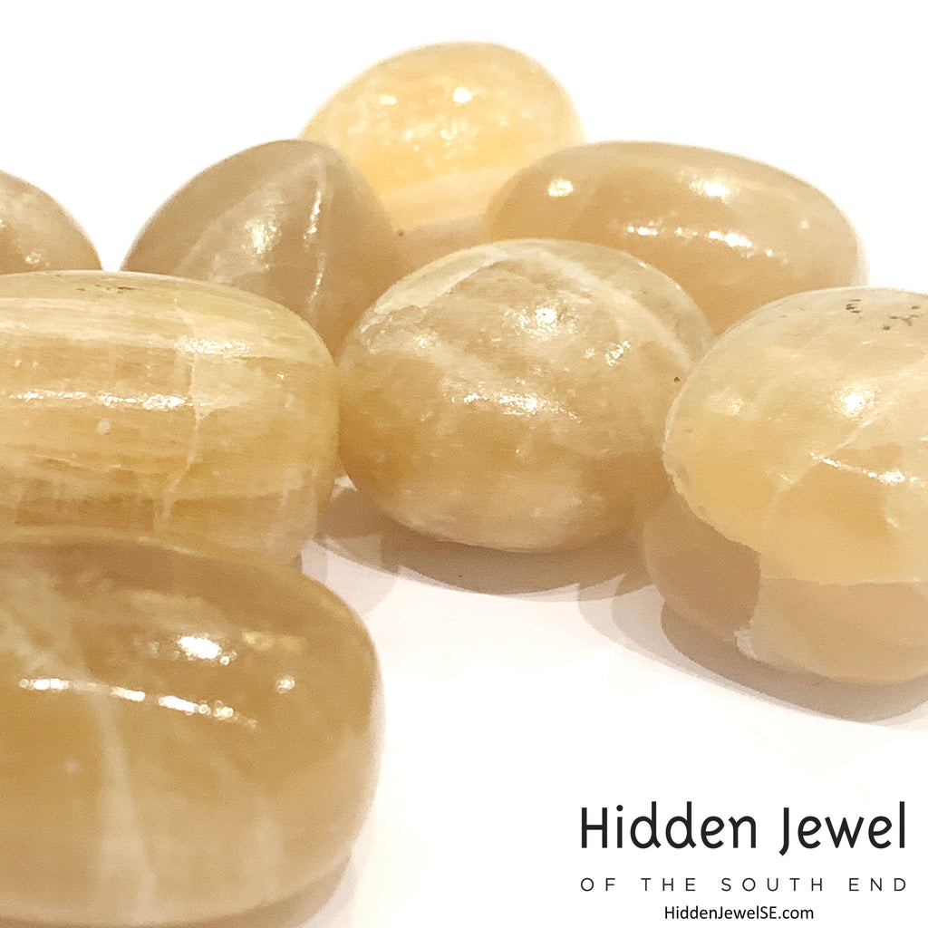 Reiki-charged Honey Calcite crystal for mental clarity and confidence, on a white background, front view.