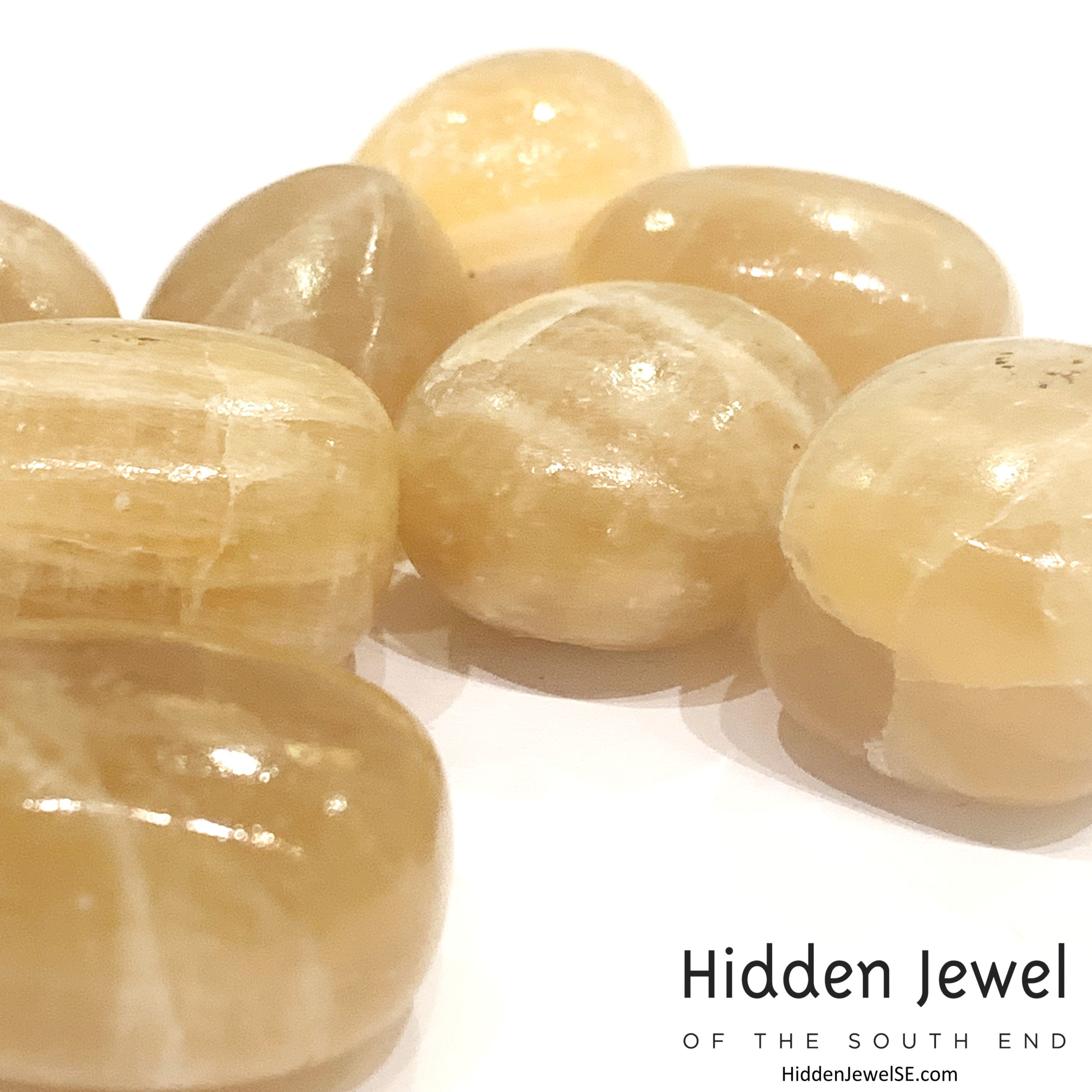 Reiki-charged Honey Calcite crystal for mental clarity and confidence, on a white background, front view.