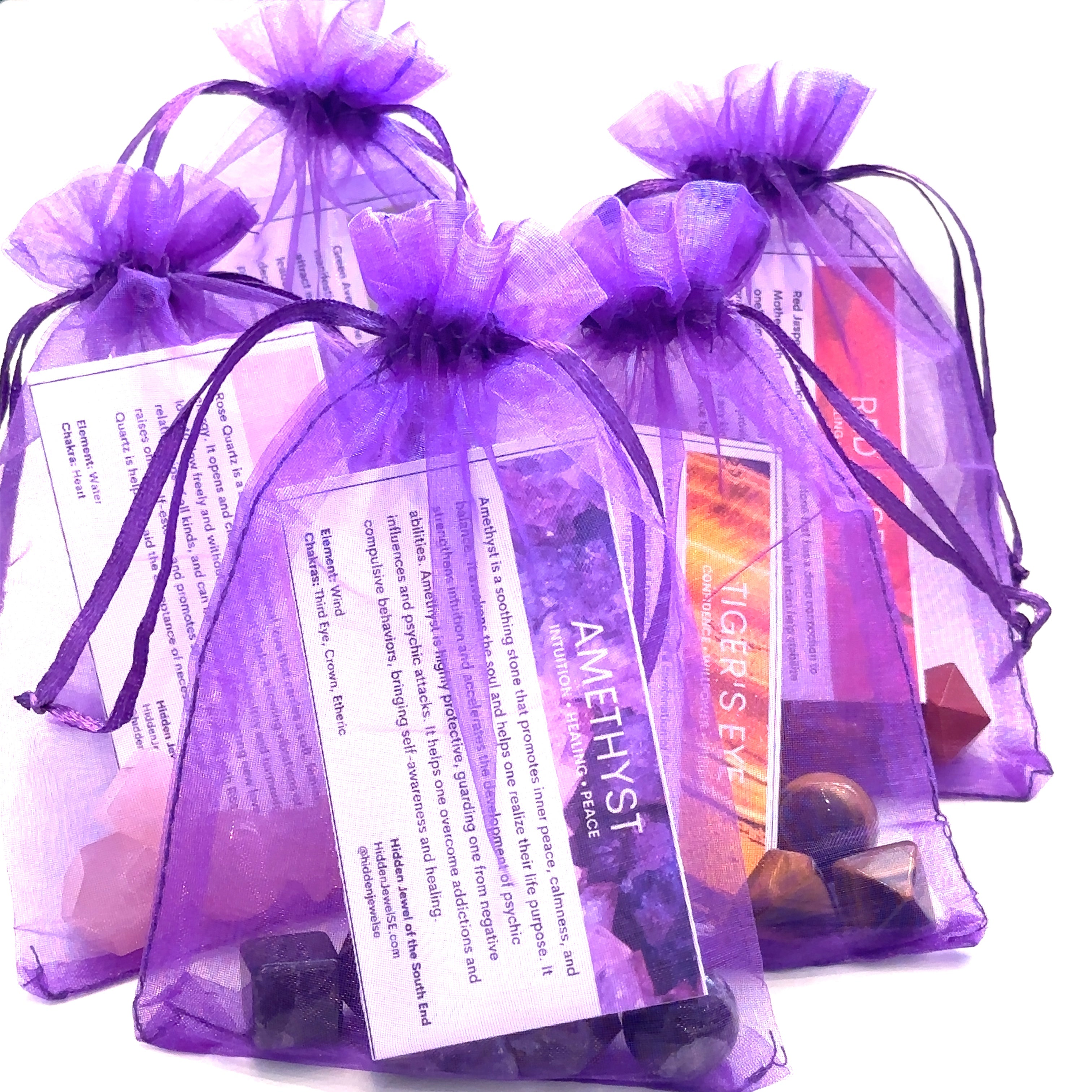 Ribbon-tied gift box containing sacred geometry set and guides on white front view