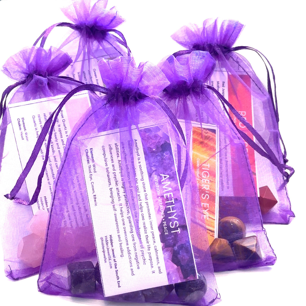 Ribbon-tied gift box containing sacred geometry set and guides on white front view