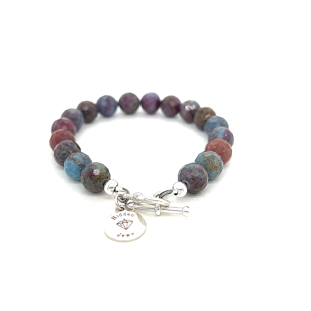 Ruby Kyanite gemstone bracelet with sterling silver toggle clasp on white background back and center overview. 