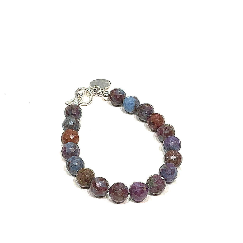 Ruby Kyanite gemstone bracelet with sterling silver toggle clasp on white background front and close up overview. 